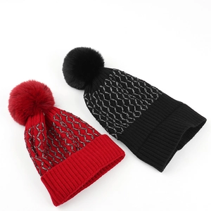 Winter glitter plaid knit beanies in red and black with large fluffy pom poms