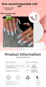 Detailed view of black and white press-on nails with flame and flower patterns