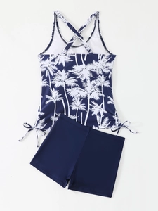 Flat lay of coconut print tankini top with drawstring and navy boyleg bikini bottoms