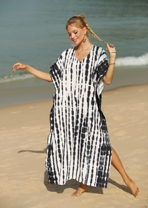 Detail of V-neckline and black and white vertical tie-dye stripes on a beach kaftan
