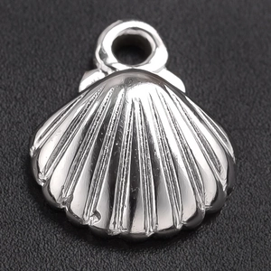Macro shot of silver 304 stainless steel shell pendant with detailed sea texture