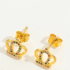 Detailed close-up of golden crown earrings with colorful gemstones on a white background