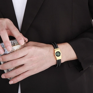 Close-up of a woven leather bracelet with an integrated functional compass for men