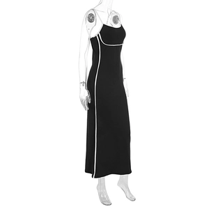 Detail of slim fit black slip dress with white contrast piping and high stretch fabric