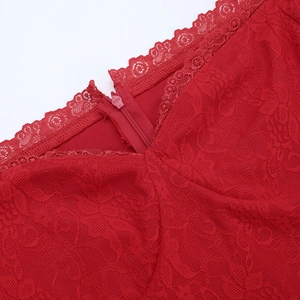 Detailed macro view of the red lace dress featuring an invisible zipper and fine stitching
