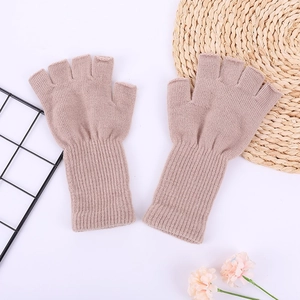 Detail of khaki ribbed knit fingerless gloves showing soft acrylic texture and long cuffs