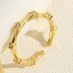 Macro detail of 14K gold plated bamboo ring featuring sparkling zircon stones