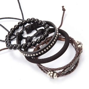 Detail view of four-piece layered set with leather bands, beads and silver feather charm