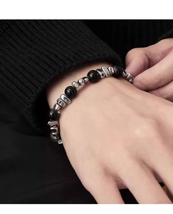 Close-up of minimalist black hematite beads and irregular titanium steel beads on wrist