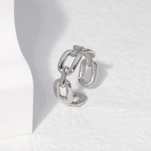 Macro view of adjustable silver Cuban link chain ring with high-polish metallic finish