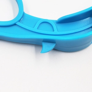 Blue plastic ring fruit peeler for oranges and apples shown on a white background
