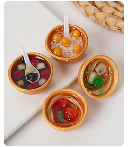 Top view of four miniature food bowls featuring Chinese noodles and desserts on white background