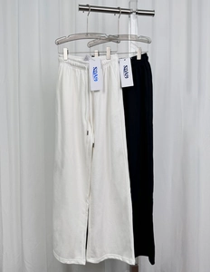 Detail of drawstring waistband on straight leg joggers in black and white colors
