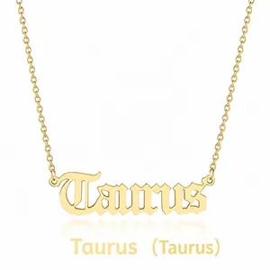 Detailed view of a gold Taurus zodiac pendant necklace with gothic lettering on a chain