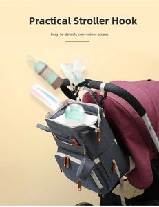 Detail of black stroller hooks holding a gray diaper bag on a pushchair handle