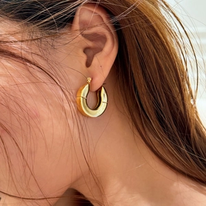 Elegant 18k gold plated stainless steel chunky C-hoop earrings worn by a model