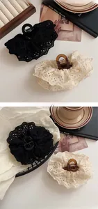 Detail of French lace embroidery hair claw clips in black and cream for women