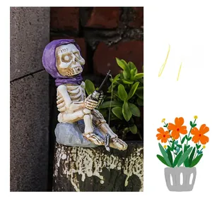 Macro shot of a resin skeleton figurine fishing in a purple hood on a stone base