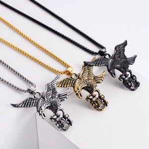 Eagle pendant with skull in silver, gold, and black finishes on geometric steps
