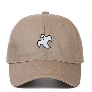 Close-up of white ghost embroidery on dark khaki cotton baseball cap with curved brim