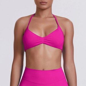 Front detail of rose red halter sports bra with center ruching and elastic fabric