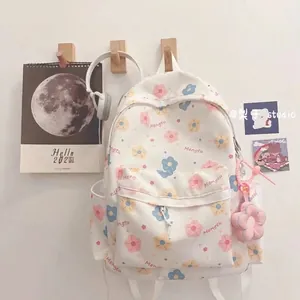 Cute Japanese style floral backpack in beige with pastel prints and pink flower charm