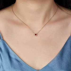 Elegant 925 silver gold necklace with ruby red zircon pendant worn on model's neck