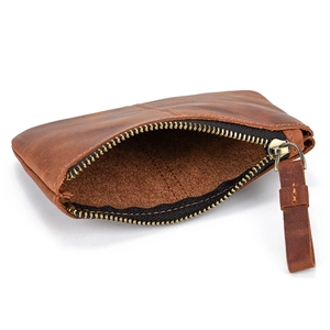 Macro shot of a dark brown vintage crazy horse leather coin purse with a metal zipper