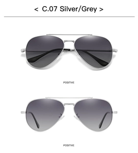 Detailed view of silver pilot sunglasses with gray gradient lenses and model engraving