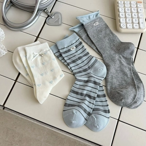 Three-pack of mid-calf socks in cream and blue with heart patterns and striped details