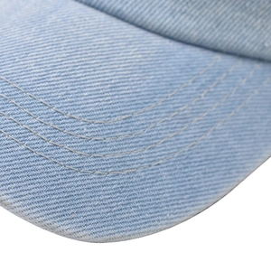 Close-up of light blue washed denim cap brim with triple-row stitching detail