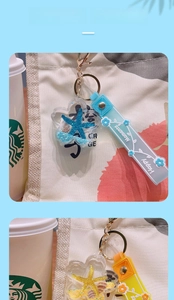 Close-up of ocean starfish liquid sand keychain with glitter and silicone wrist strap
