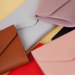 Detailed view of colorful envelope wallets with textured lychee grain leather finish