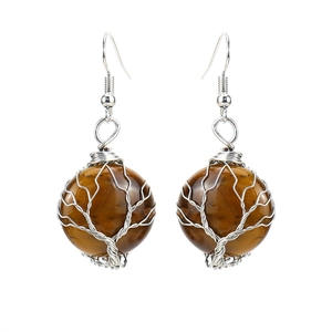 Macro view of handmade wire-wrapped tree of life earrings with brown tiger eye stones