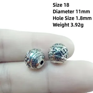Macro view of 11mm antique silver alloy lantern beads with intricate dragon scale texture