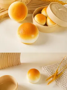 Close-up of realistic golden PU squishy bread toy with detailed texture and bamboo steamer