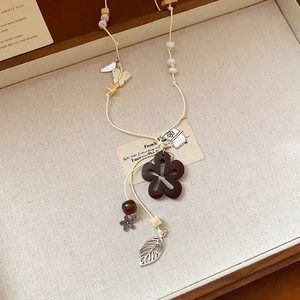Bohemian wax rope necklace with hollow wooden flower and leaf pendants in a gift box