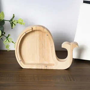 Whale-shaped wooden piggy bank with clear acrylic panel and visible screw fasteners