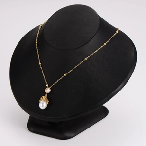 Irregular octopus pearl pendant necklace set in gold stainless steel on display