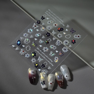 Artistic 3D nail stickers featuring white flowers, butterflies, and elegant pearl chain designs