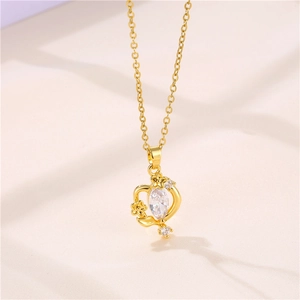 Detail shot of a gold floral necklace featuring a central clear zircon on soft fabric