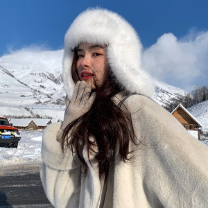 Winter faux fur trapper hat for women styled with a matching white plush coat outdoors