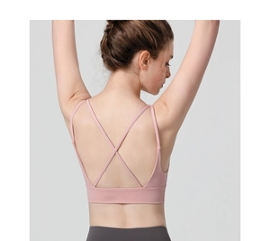 Detail view of pink sports bra featuring criss-cross back straps and open back design