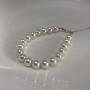 Close-up of aurora pearl bracelet with 14k gold-filled clasp and iridescent white pearls