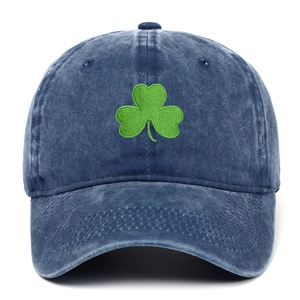 Detail of green clover embroidery on vintage washed navy blue cotton baseball cap