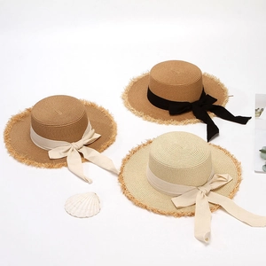 Women's summer straw sun hats with wide ribbon bows and frayed edges in three colors