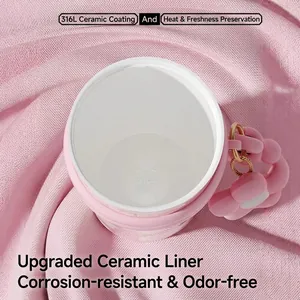 Pink insulated tumbler with 316L ceramic liner and floral charm on a pink fabric background