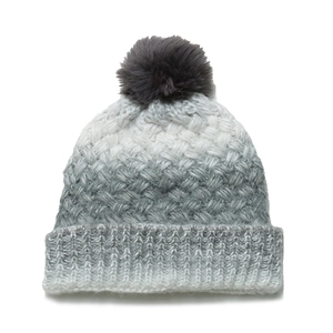 Detail of grey gradient chunky knit beanie featuring a fluffy faux fur pom-pom topper