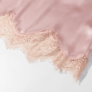 Gros plan sur le satin rose avec une bordure délicate en dentelle de cils