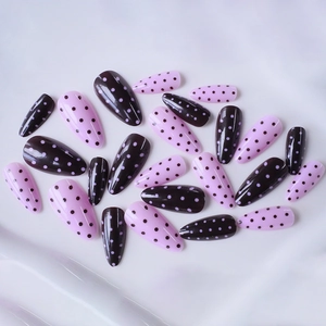 Pink and dark purple almond press-on nails with minimalist polka dot design patterns